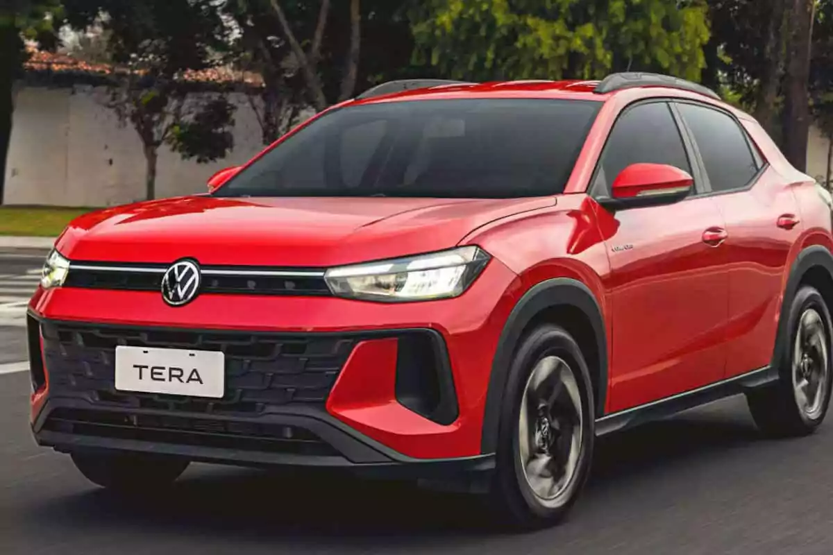 Red Volkswagen Tera SUV driving down a street with trees in the background Red Volkswagen Tera SUV driving down a street with trees in the background