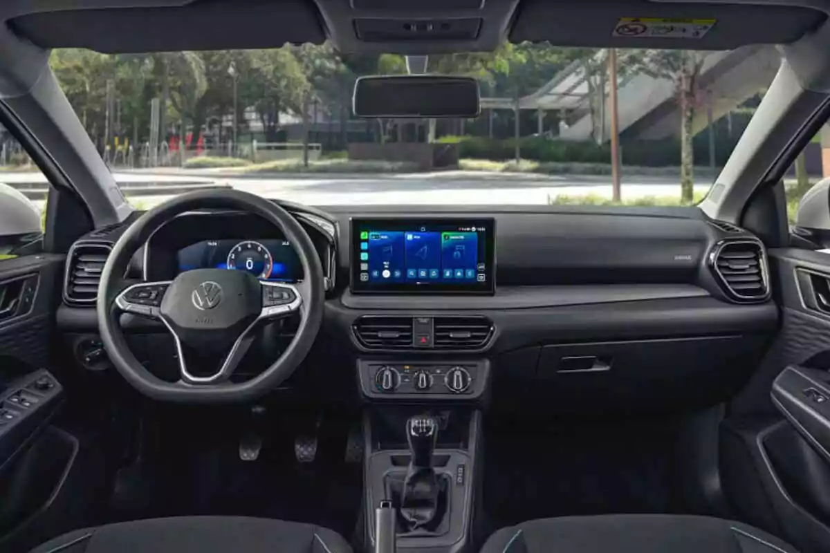 Interior of a Volkswagen car with a multifunction steering wheel, central touchscreen, and manual air conditioning controls Interior of a Volkswagen car with a multifunction steering wheel, central touchscreen, and manual air conditioning controls