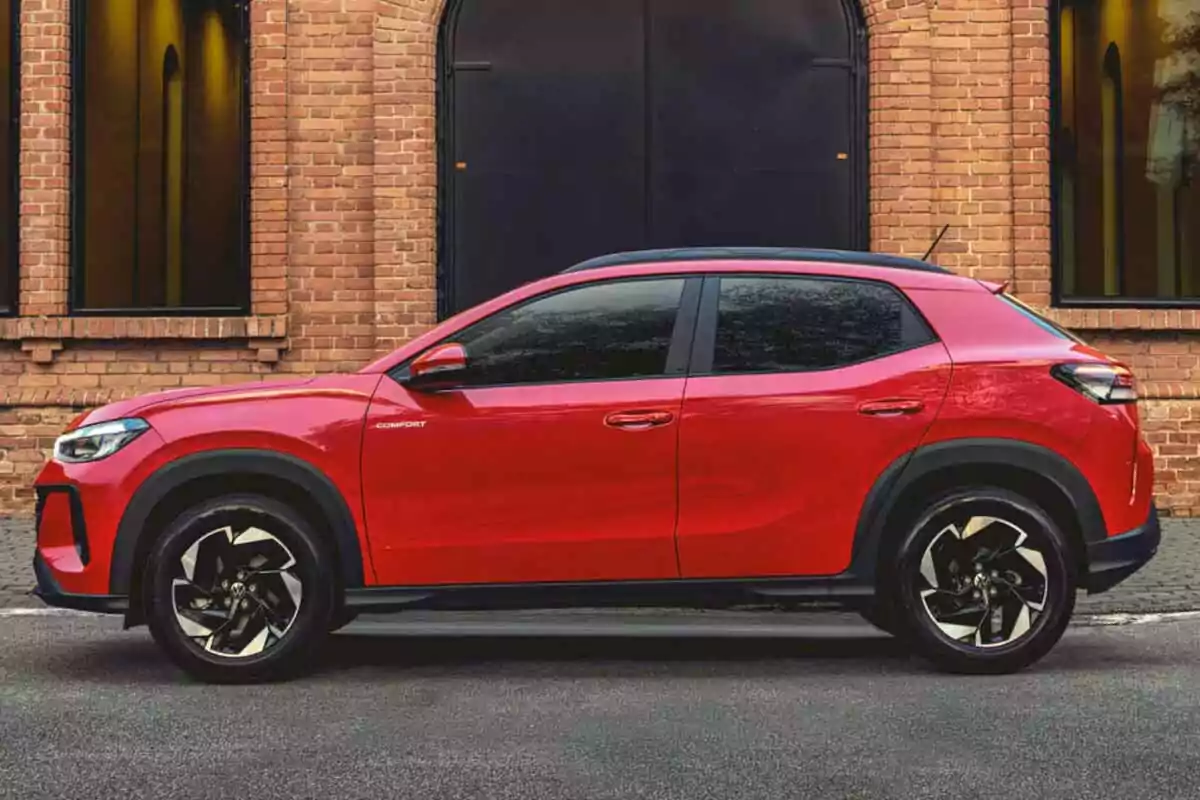 Red SUV parked in front of a brick building with large windows Red SUV parked in front of a brick building with large windows