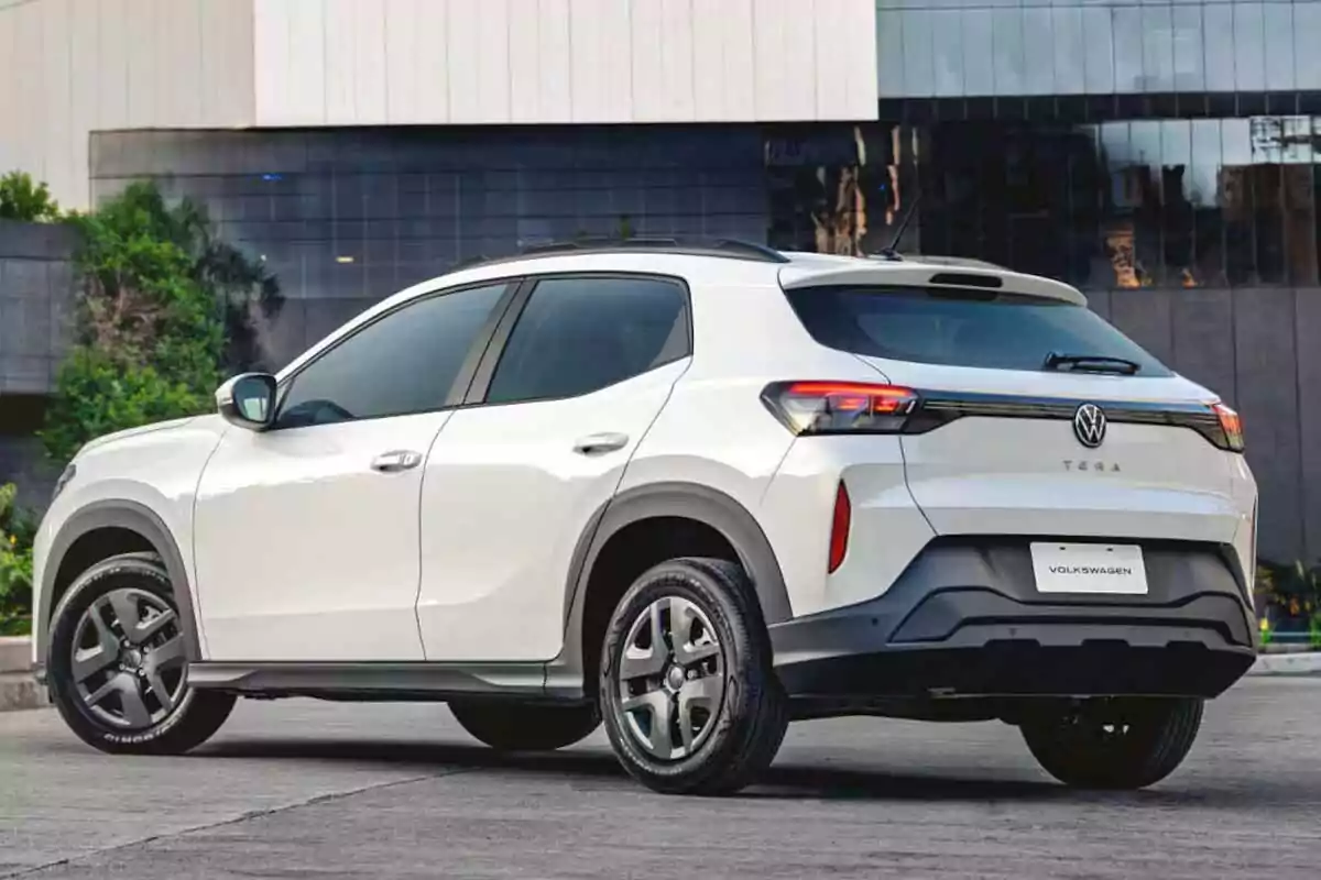 White Volkswagen Tera SUV parked on a street in front of a modern building White Volkswagen Tera SUV parked on a street in front of a modern building