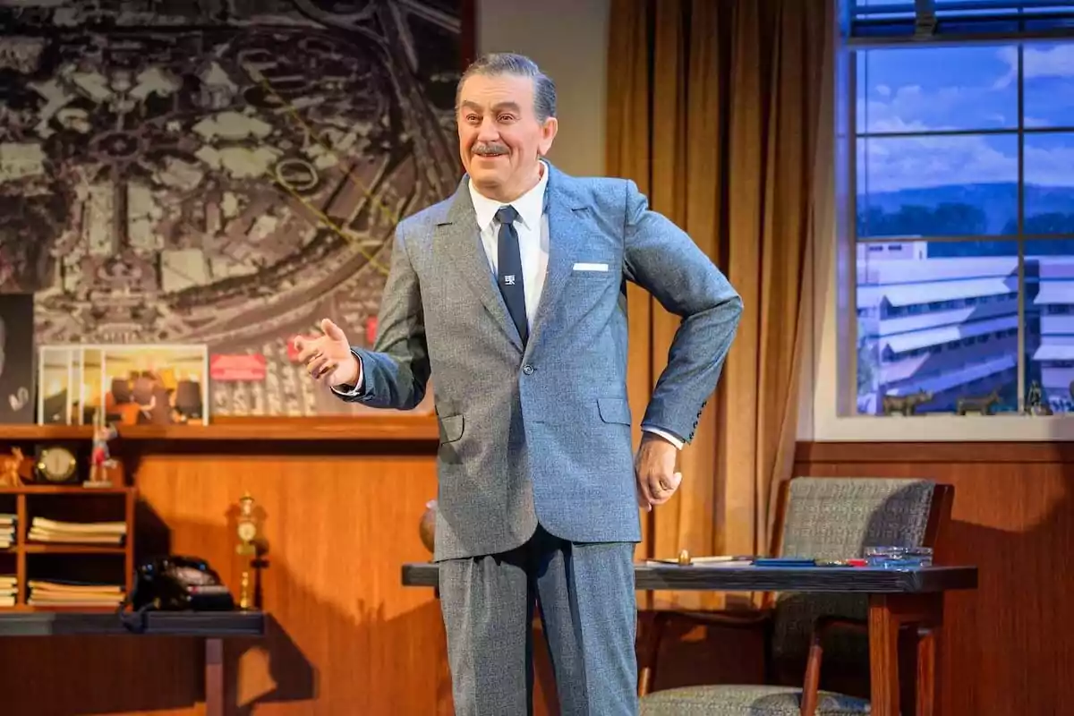 Wax figure of a man with a mustache and a gray suit in an office with a desk, chair, bookshelf, and a large map on the wall. Wax figure of a man with a mustache and a gray suit in an office with a desk, chair, bookshelf, and a large map on the wall.