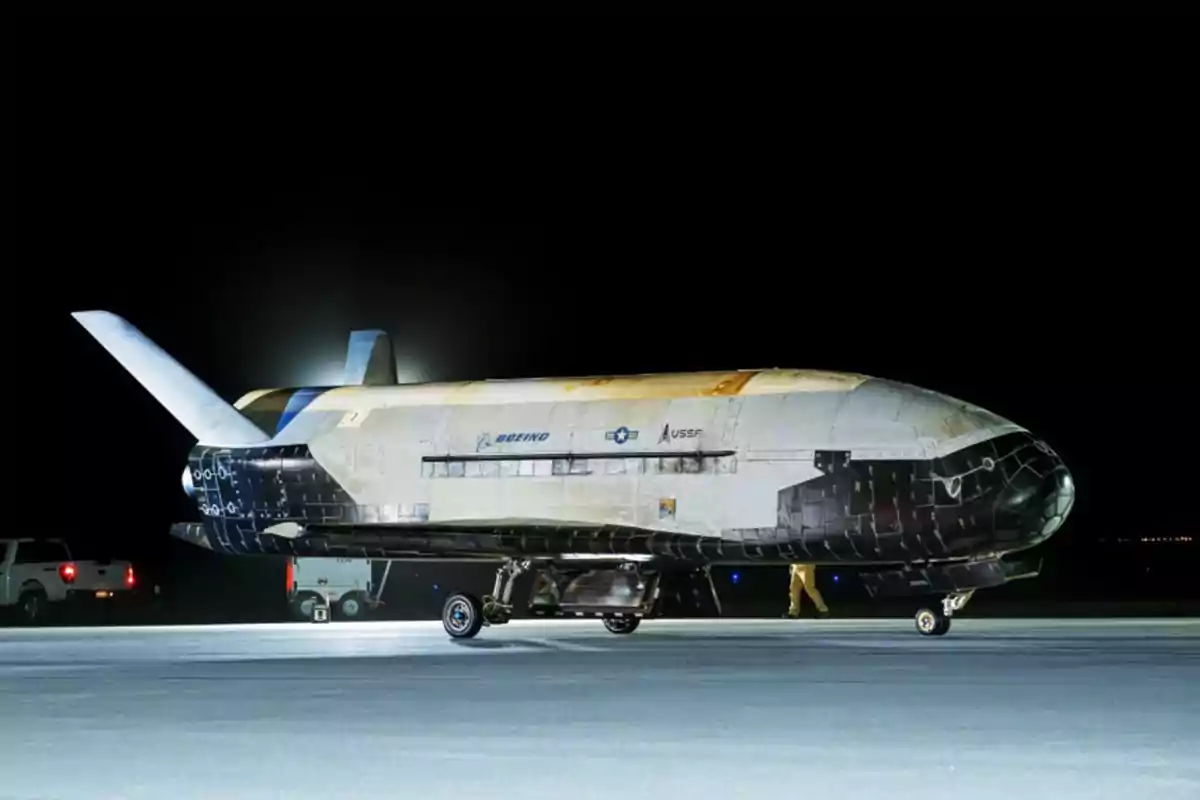 Uncrewed X-37B space shuttle of the United States Space Force on a runway illuminated at night Uncrewed X-37B space shuttle of the United States Space Force on a runway illuminated at night