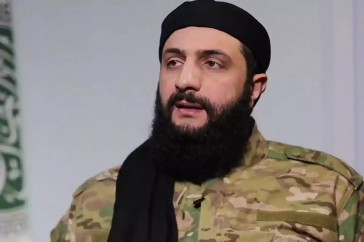 Man with a beard and military camouflage clothing looking forward Man with a beard and military camouflage clothing looking forward