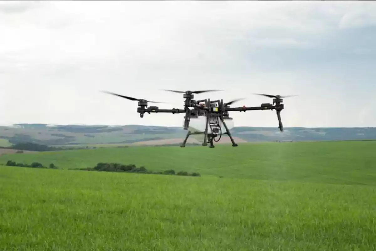 Drone flying over a green field with hills in the background on a cloudy day Drone flying over a green field with hills in the background on a cloudy day