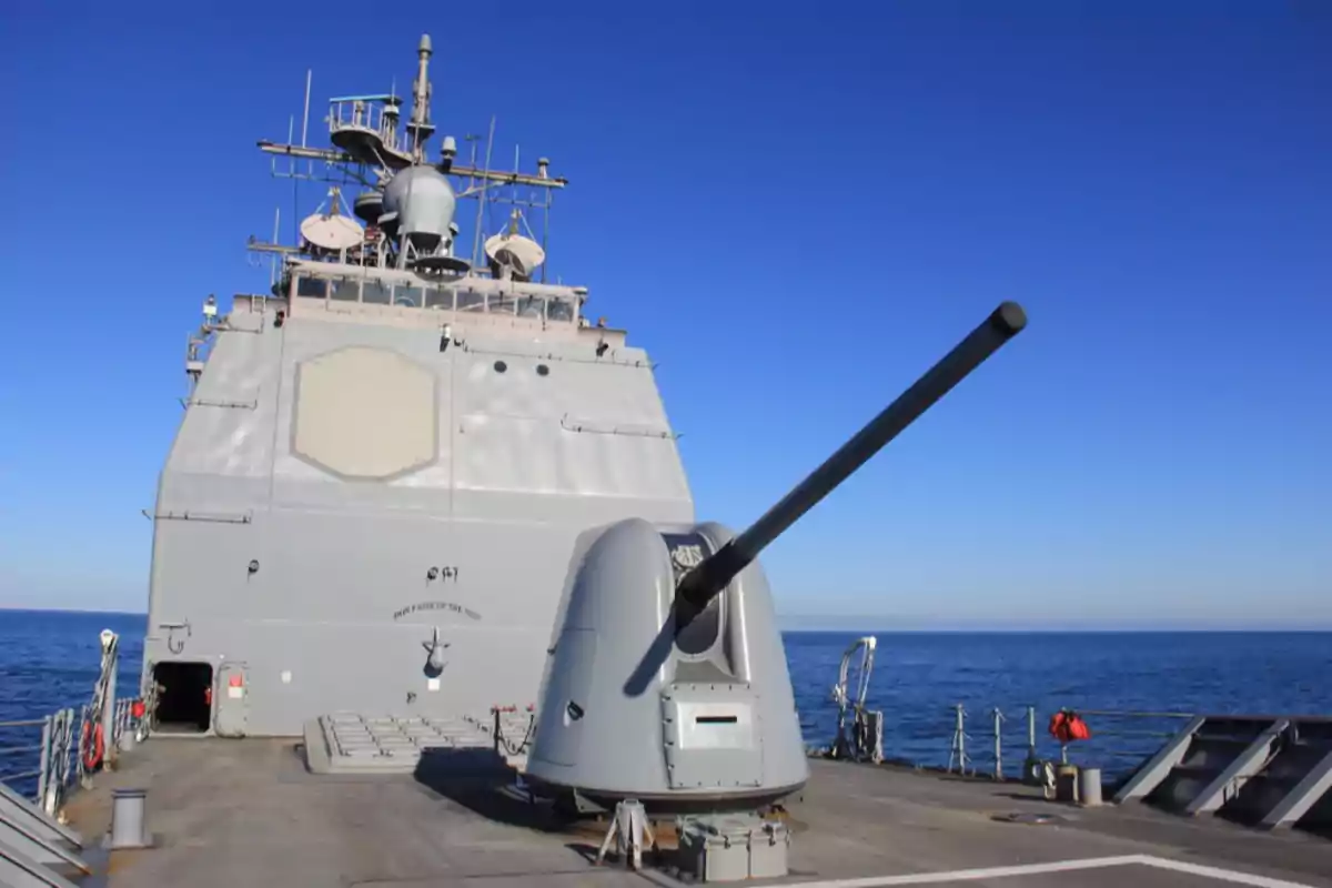 Warship sailing on the sea with a cannon on the deck and clear sky Warship sailing on the sea with a cannon on the deck and clear sky
