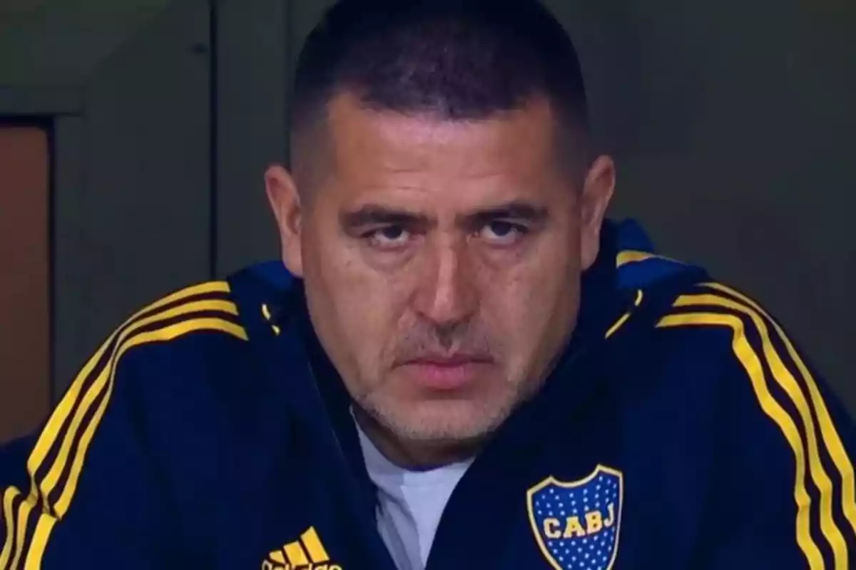 Man with a serious expression wearing a blue jacket with yellow details and the CABJ crest Man with a serious expression wearing a blue jacket with yellow details and the CABJ crest