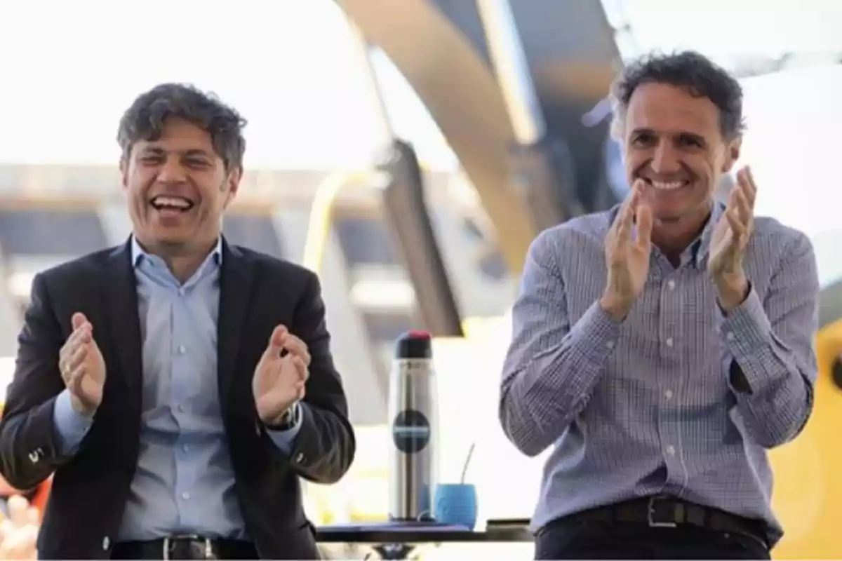 Two men smile and clap while sitting next to each other with a thermos and a mate on the table in front of them. Two men smile and clap while sitting next to each other with a thermos and a mate on the table in front of them.