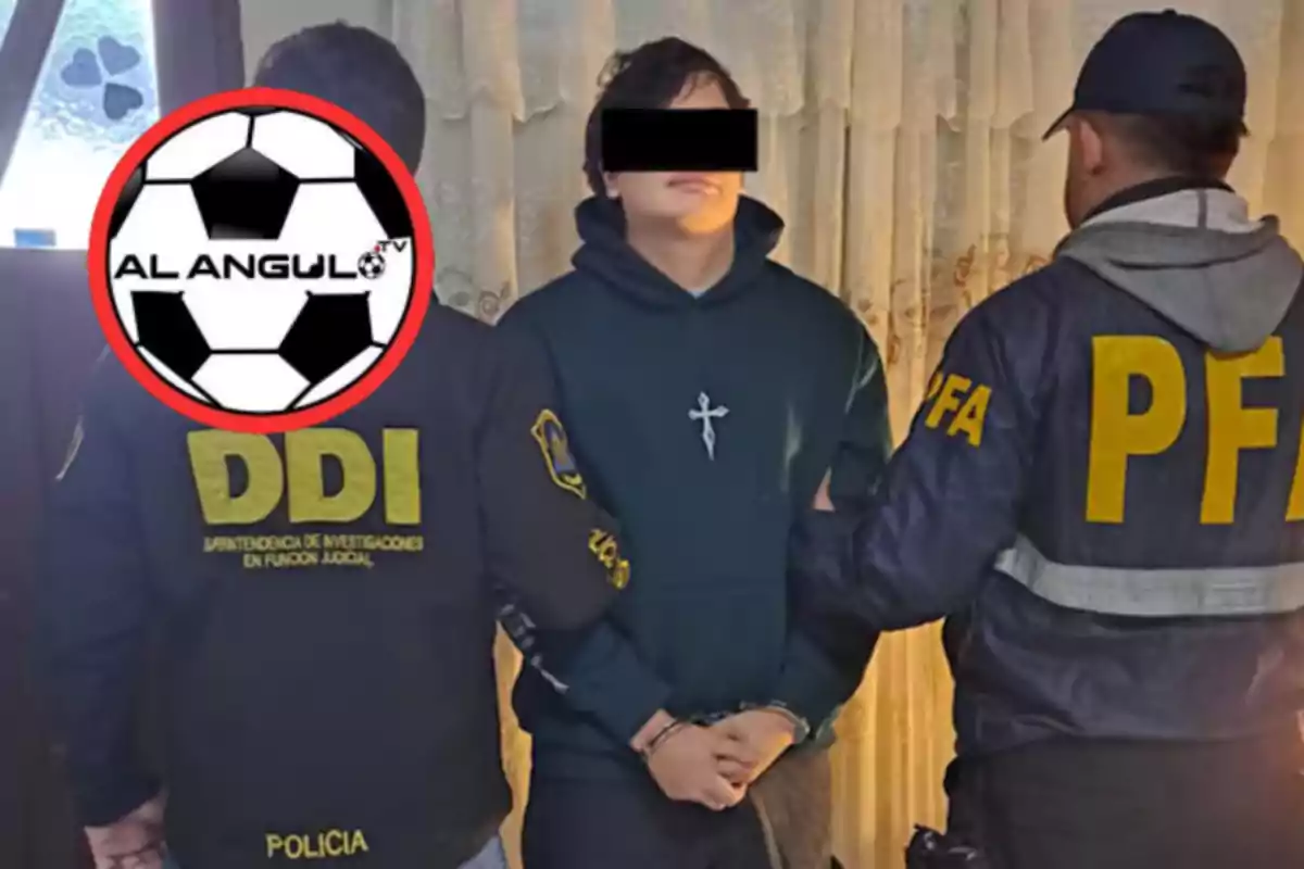 Un joven esposado con los ojos cubiertos es escoltado por dos agentes de policía con chaquetas que tienen las siglas DDI y PFA en la espalda