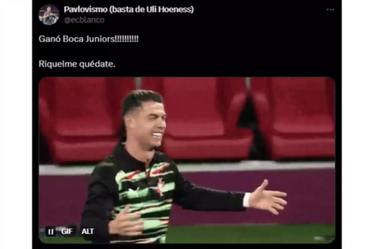 A smiling man with open arms celebrating in a stadium with red seats A smiling man with open arms celebrating in a stadium with red seats