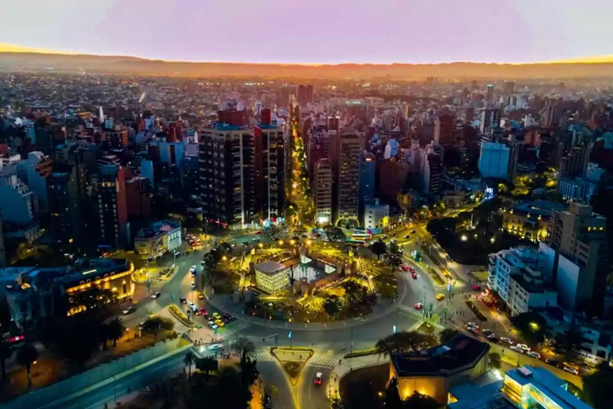 Aerial view of a city at sunset with tall buildings and a brightly lit roundabout in the center Aerial view of a city at sunset with tall buildings and a brightly lit roundabout in the center