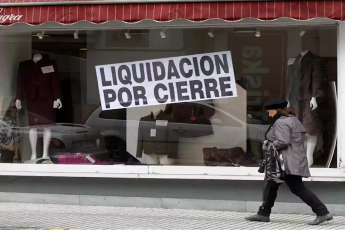 Clothing store window with a large sign that says Clothing store window with a large sign that says