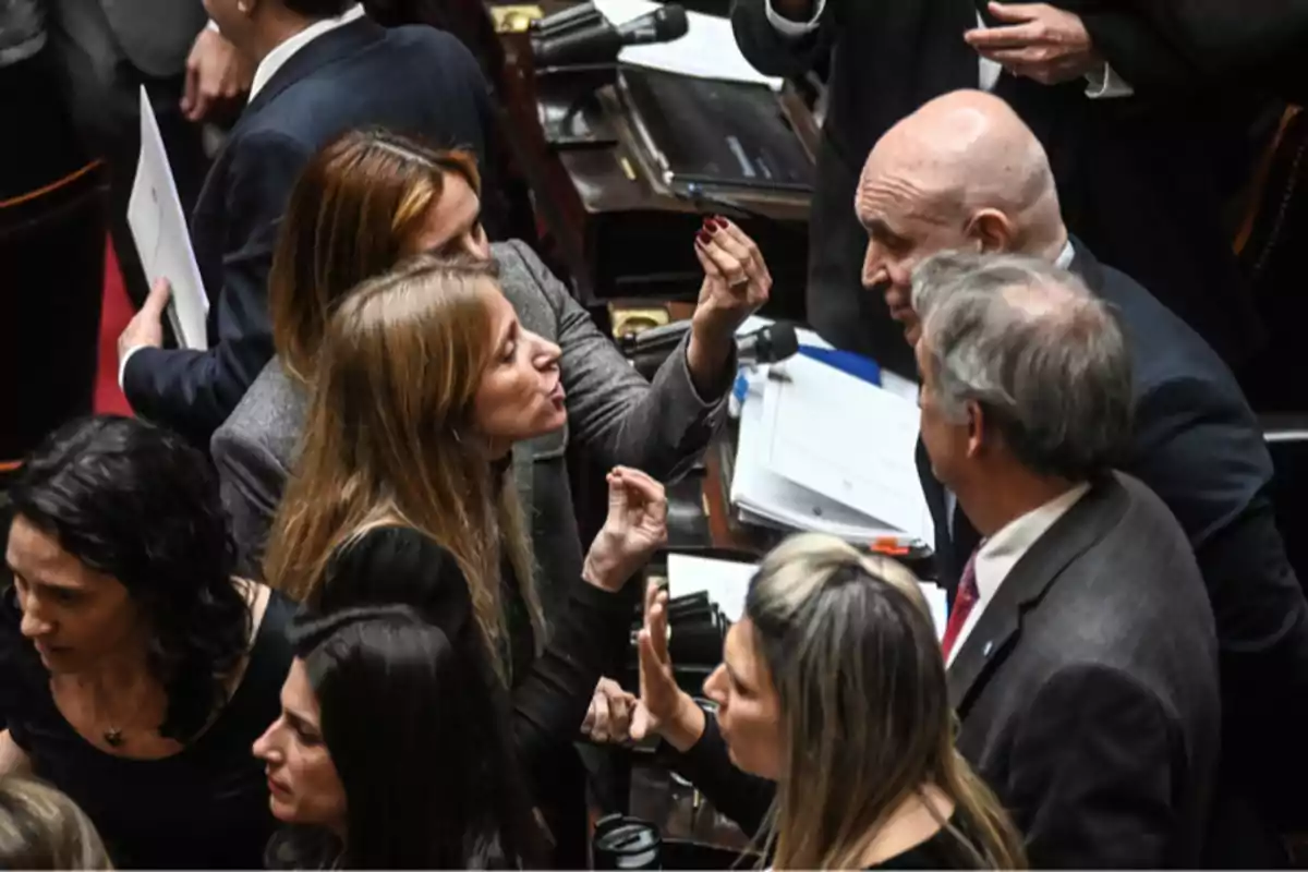 Group of people arguing heatedly in a formal setting with papers and folders on a table Group of people arguing heatedly in a formal setting with papers and folders on a table