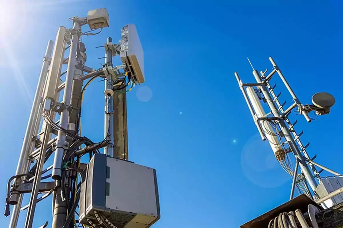 Telecommunication towers with antennas and cables under a clear blue sky Telecommunication towers with antennas and cables under a clear blue sky