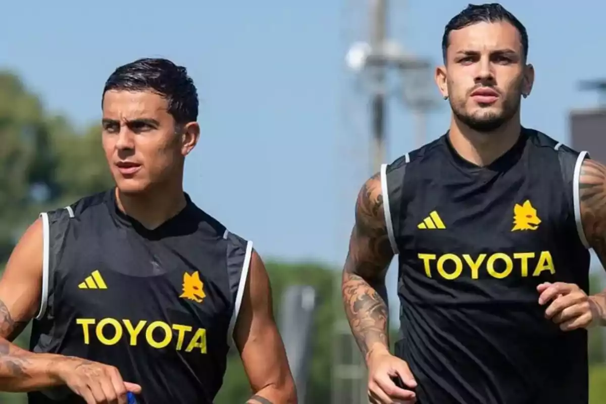 Two players training outdoors wearing black sleeveless jerseys with the Toyota logo and a yellow wolf. Two players training outdoors wearing black sleeveless jerseys with the Toyota logo and a yellow wolf.
