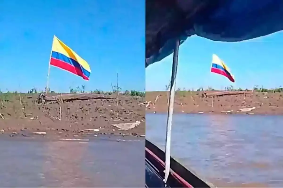Bandera de Colombia ondeando en la orilla de un río vista desde una embarcación bajo un cielo despejado Bandera de Colombia ondeando en la orilla de un río vista desde una embarcación bajo un cielo despejado