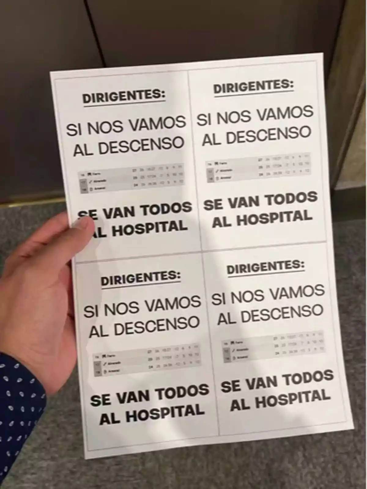 Person holds a sheet with four identical cutouts containing a threatening message directed at football club officials, warning that if the team is relegated, everyone will end up in the hospital, accompanied by a small standings table. Person holds a sheet with four identical cutouts containing a threatening message directed at football club officials, warning that if the team is relegated, everyone will end up in the hospital, accompanied by a small standings table.