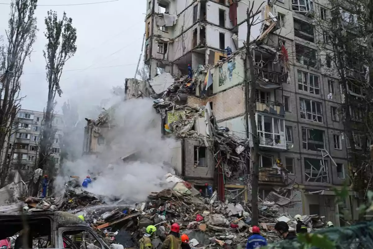 Partially collapsed residential building with smoke and debris as rescuers work in the affected area Partially collapsed residential building with smoke and debris as rescuers work in the affected area