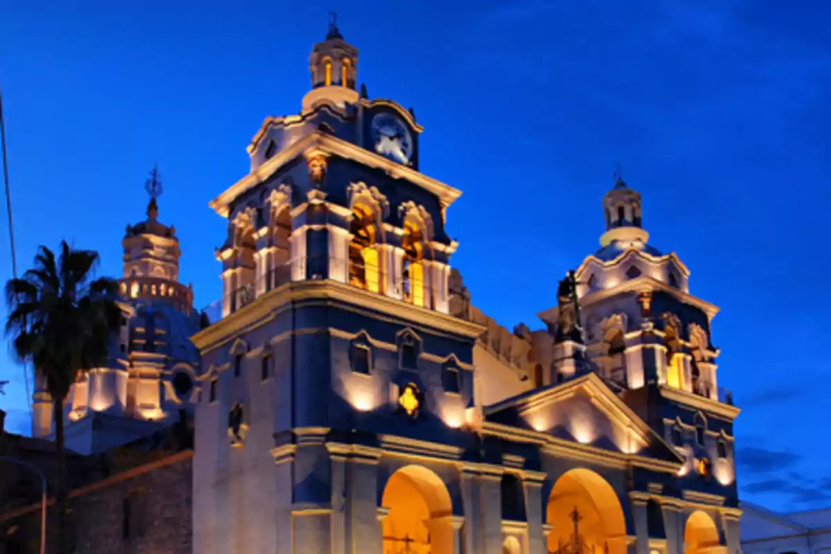 Cathedral illuminated at dusk with a deep blue sky in the background Cathedral illuminated at dusk with a deep blue sky in the background