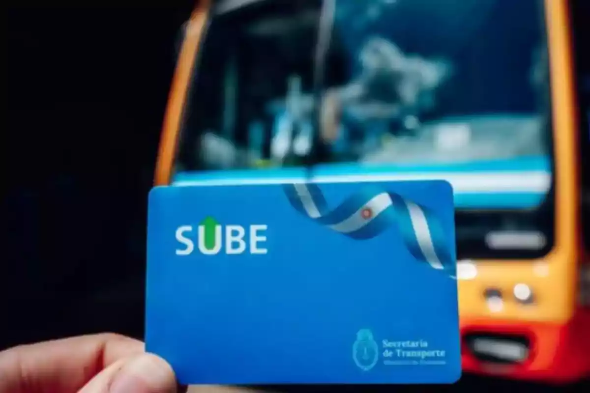 Person holding a SUBE card in front of a bus in Argentina Person holding a SUBE card in front of a bus in Argentina