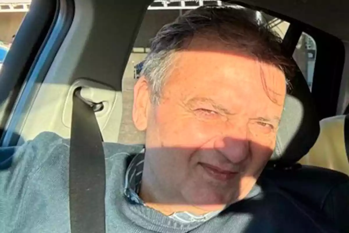 Man sitting in the driver’s seat of a car with the sun shining on his face and wearing a seatbelt Man sitting in the driver’s seat of a car with the sun shining on his face and wearing a seatbelt