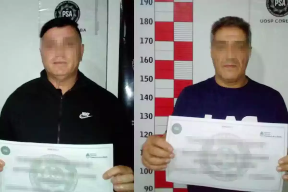 Two men with pixelated faces pose for a police booking photo holding documents in front of a background with official logos and a height chart.