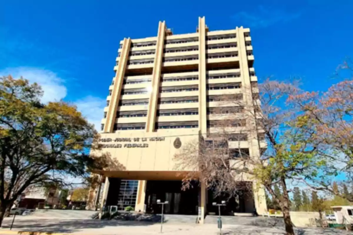 Tall courthouse building surrounded by trees under a blue sky Tall courthouse building surrounded by trees under a blue sky