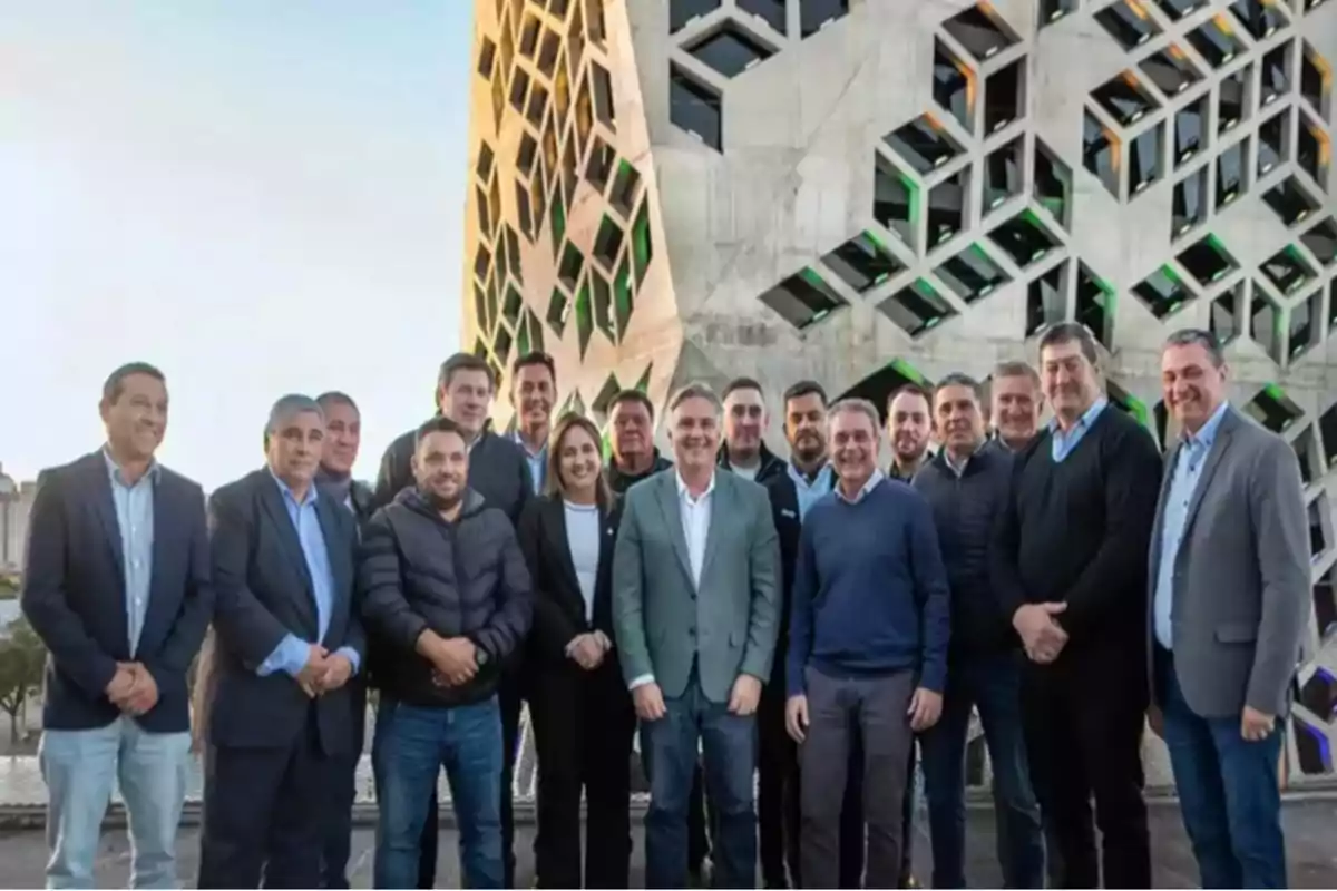 Group of people posing in front of a modern building with a geometric facade