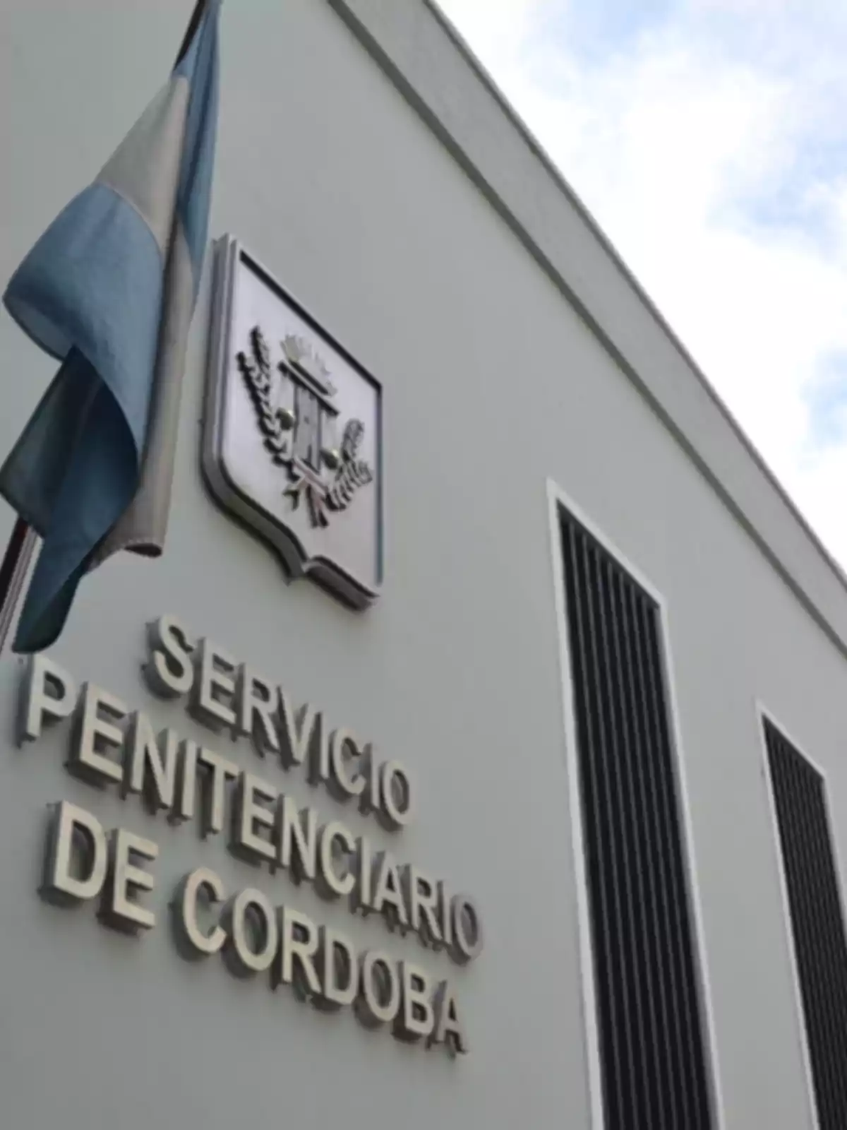 Facade of a building of the Córdoba Penitentiary Service with an Argentine flag waving Facade of a building of the Córdoba Penitentiary Service with an Argentine flag waving