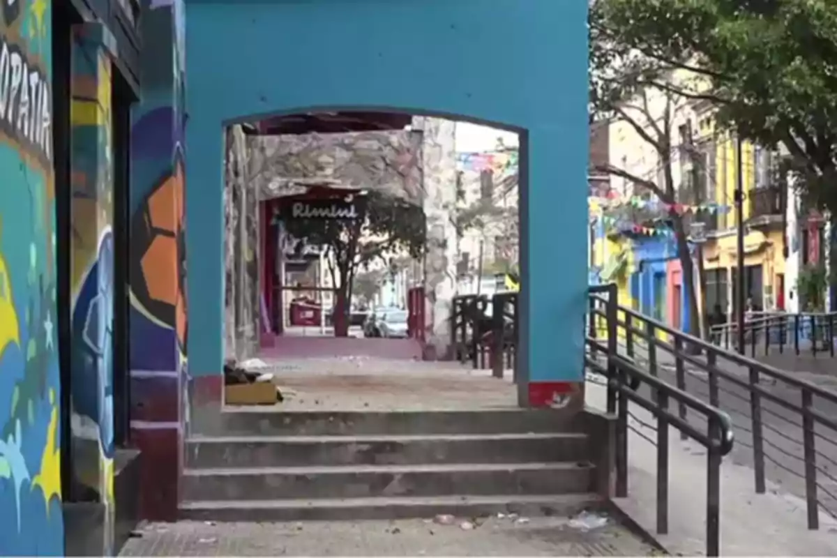 Staircase and ramp on a street with colorful walls and trees, bunting decorations, and a calm urban atmosphere Staircase and ramp on a street with colorful walls and trees, bunting decorations, and a calm urban atmosphere