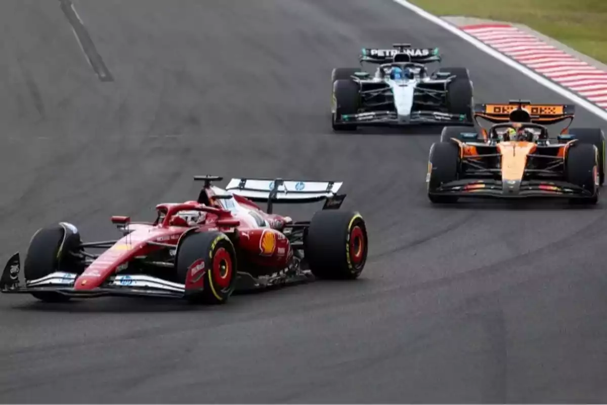 Three Formula 1 cars racing on a paved track Three Formula 1 cars racing on a paved track