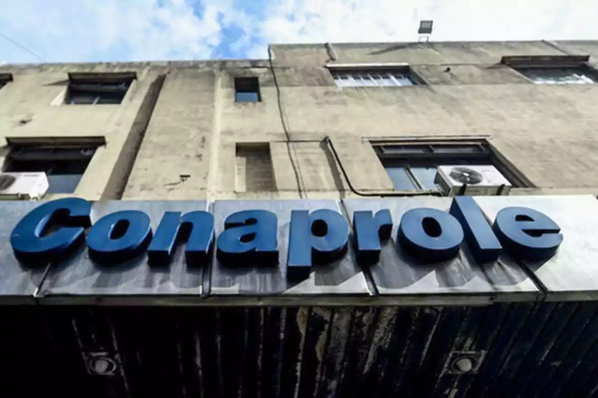 Conaprole sign on the facade of an old building under a partly cloudy sky Conaprole sign on the facade of an old building under a partly cloudy sky