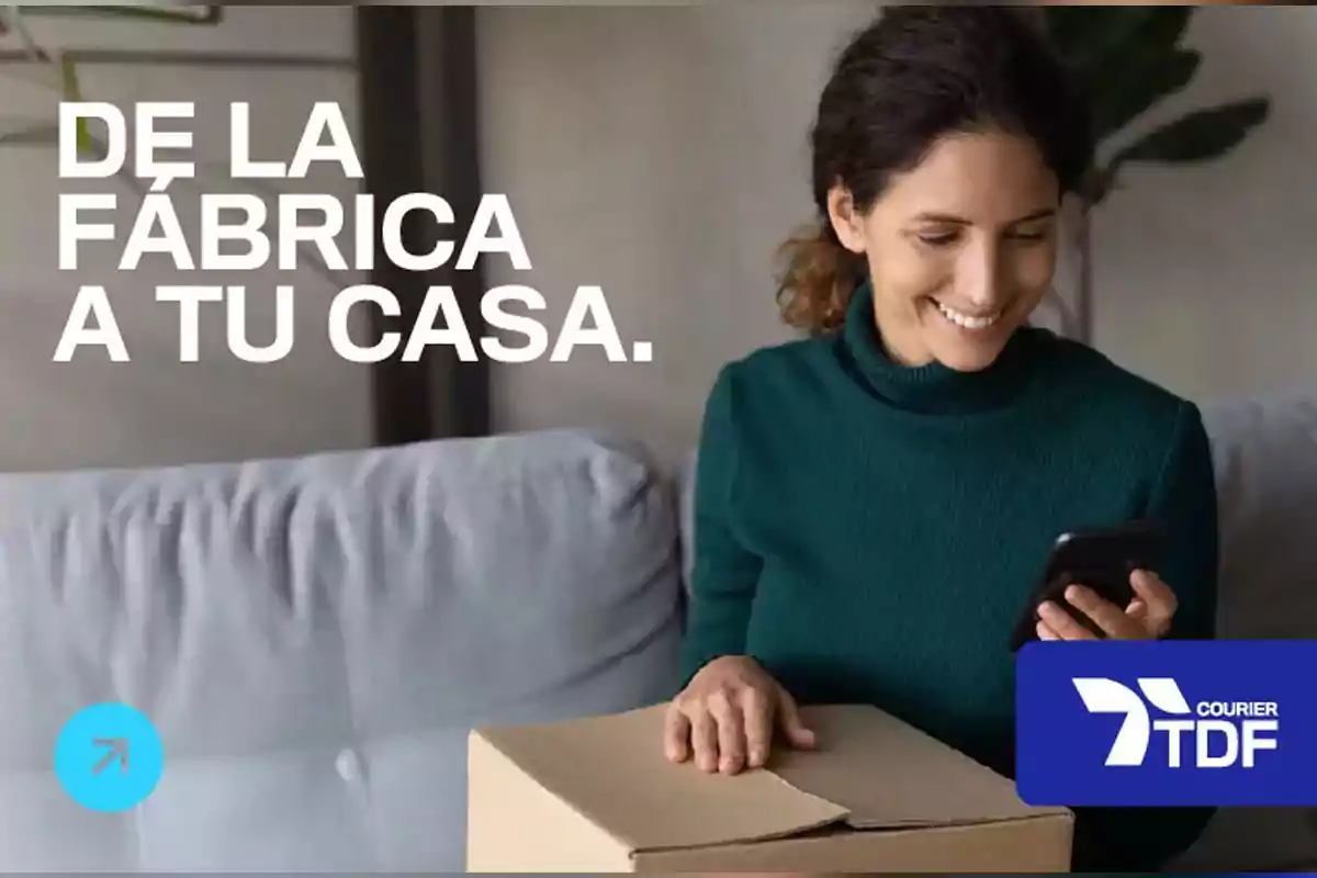 Smiling woman sitting on a sofa checking her mobile phone while holding a cardboard box with the text Smiling woman sitting on a sofa checking her mobile phone while holding a cardboard box with the text