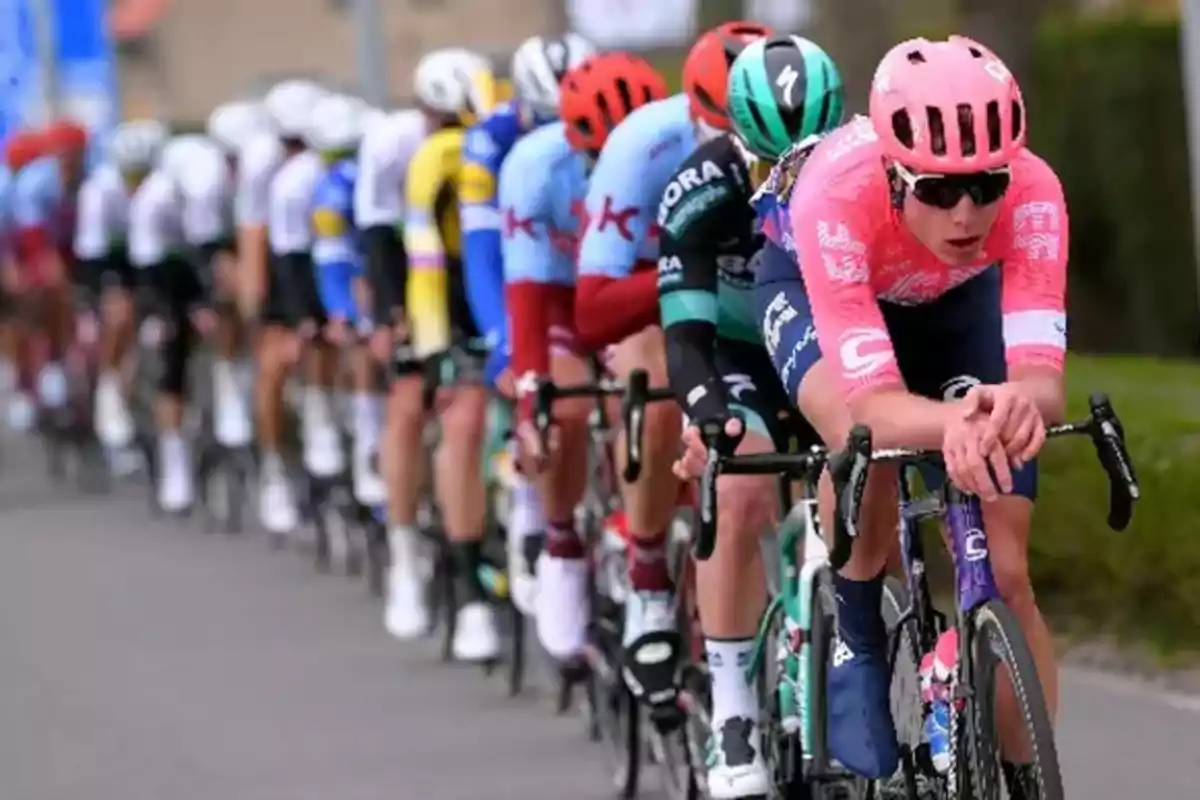 Group of cyclists competing in a race on a road Group of cyclists competing in a race on a road