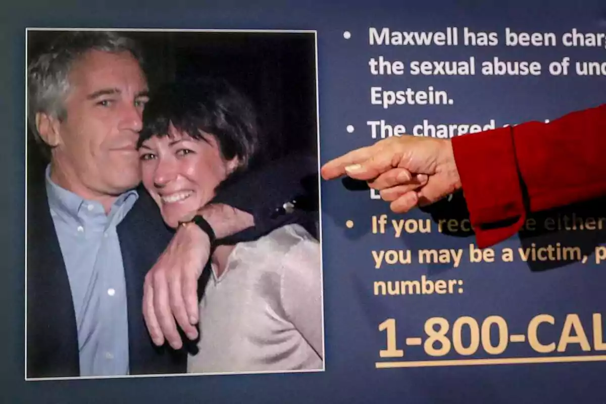 Photograph of a man and a woman hugging and smiling next to an information sign where a hand points to the text and a helpline phone number.
