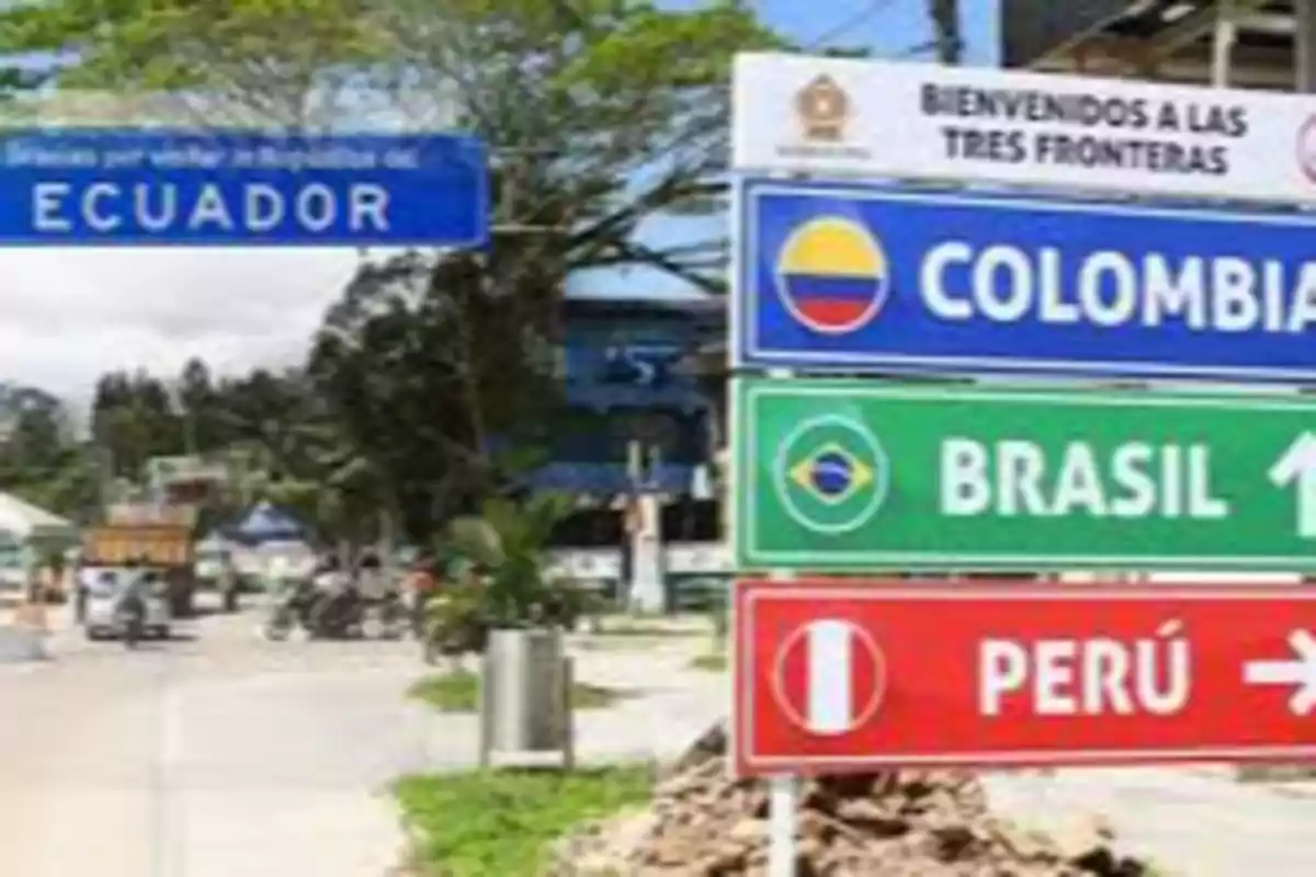 Border signs indicating directions to Colombia, Brazil, and Peru next to an Ecuador sign Border signs indicating directions to Colombia, Brazil, and Peru next to an Ecuador sign