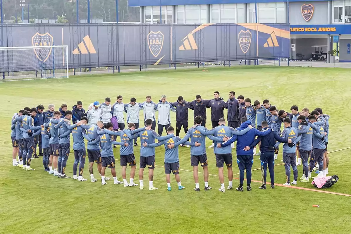 Players and coaching staff of a soccer team form a huddle on the training field of the Boca Juniors club. Players and coaching staff of a soccer team form a huddle on the training field of the Boca Juniors club.