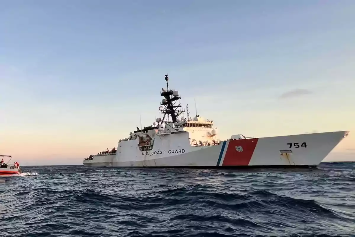 United States Coast Guard ship sailing on the sea at sunset United States Coast Guard ship sailing on the sea at sunset