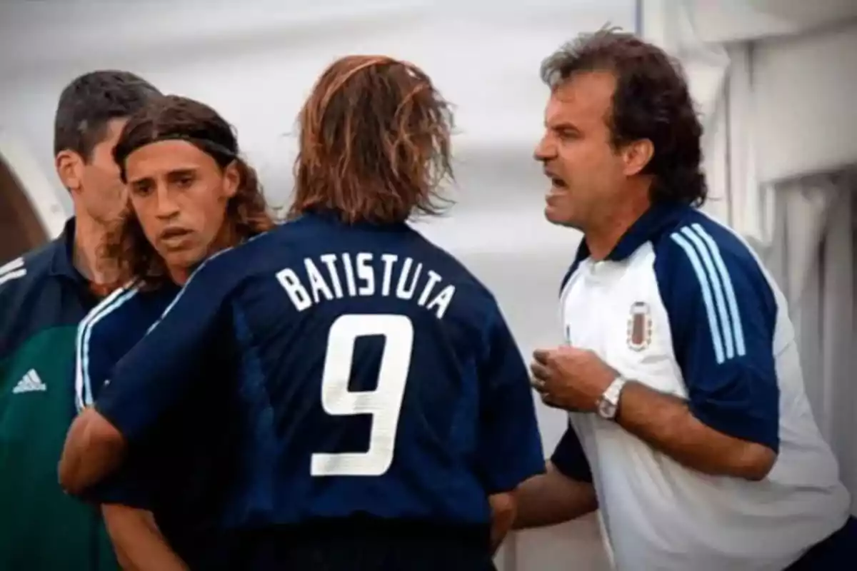 Three people in sports uniforms are arguing on the soccer field, and one of them is wearing a jersey with the name Batistuta and the number 9. Three people in sports uniforms are arguing on the soccer field, and one of them is wearing a jersey with the name Batistuta and the number 9.