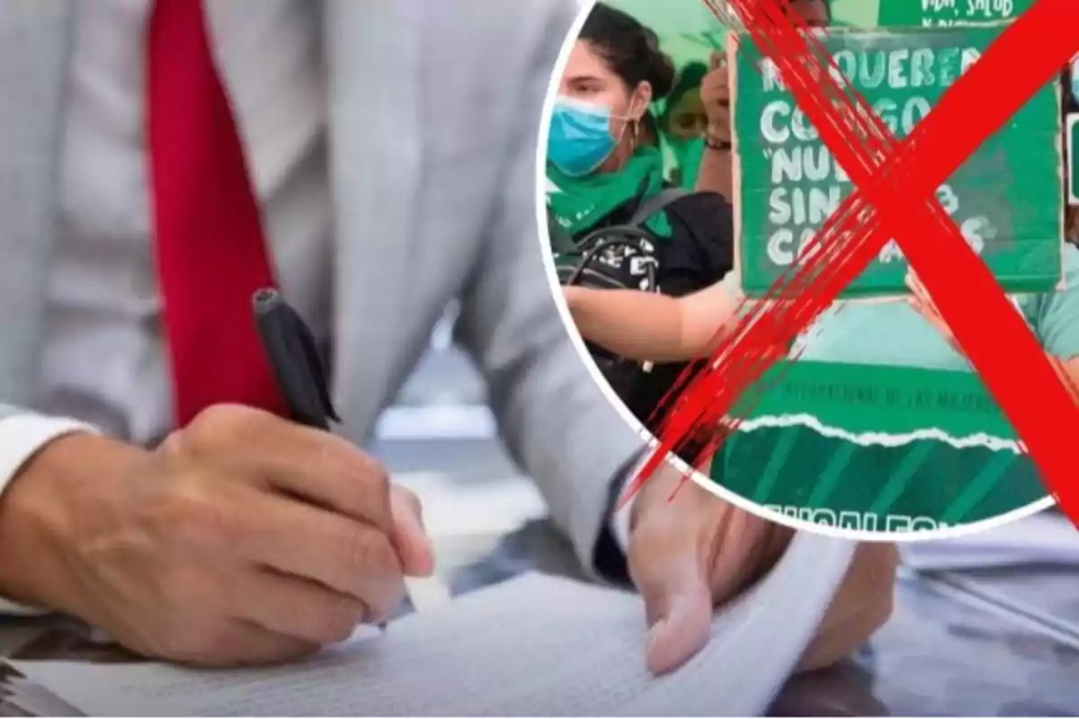 Persona con traje y corbata roja firmando un documento mientras en un círculo aparece una protesta feminista tachada con una equis roja