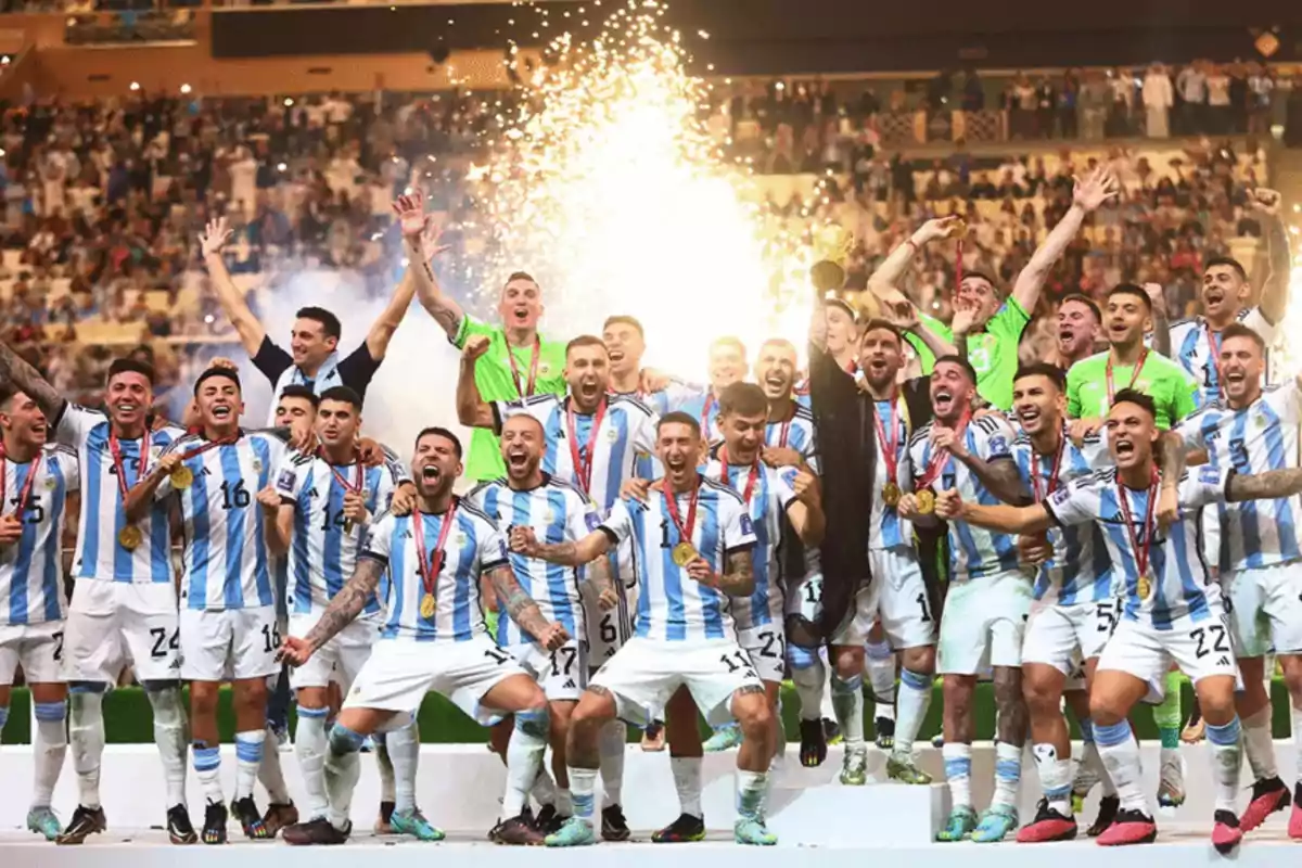 Players of the Argentine national soccer team celebrate euphorically with medals and a trophy on the podium as fireworks explode in the background and the crowd applauds them. Players of the Argentine national soccer team celebrate euphorically with medals and a trophy on the podium as fireworks explode in the background and the crowd applauds them.
