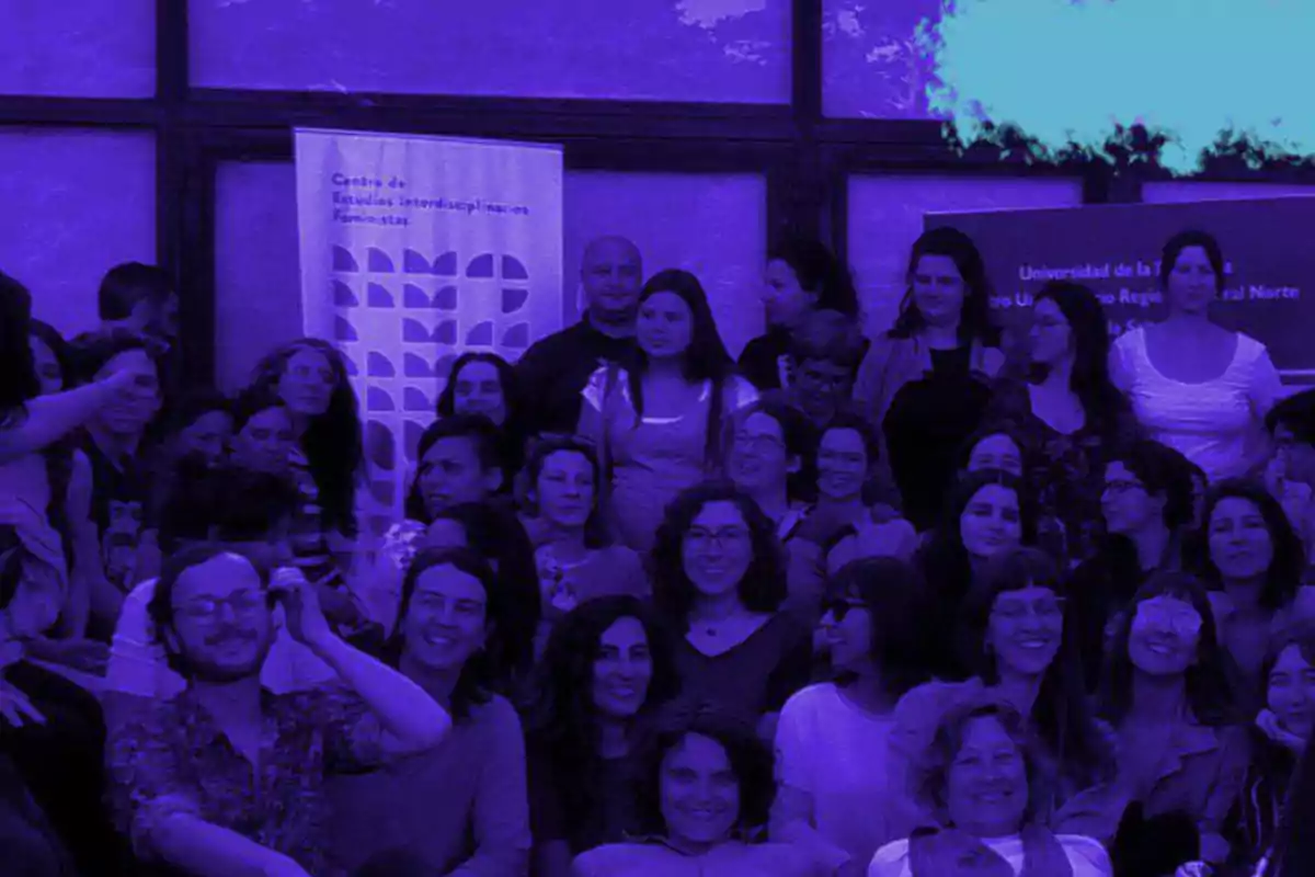 Large group of people posing together in an auditorium with a purple color filter Large group of people posing together in an auditorium with a purple color filter