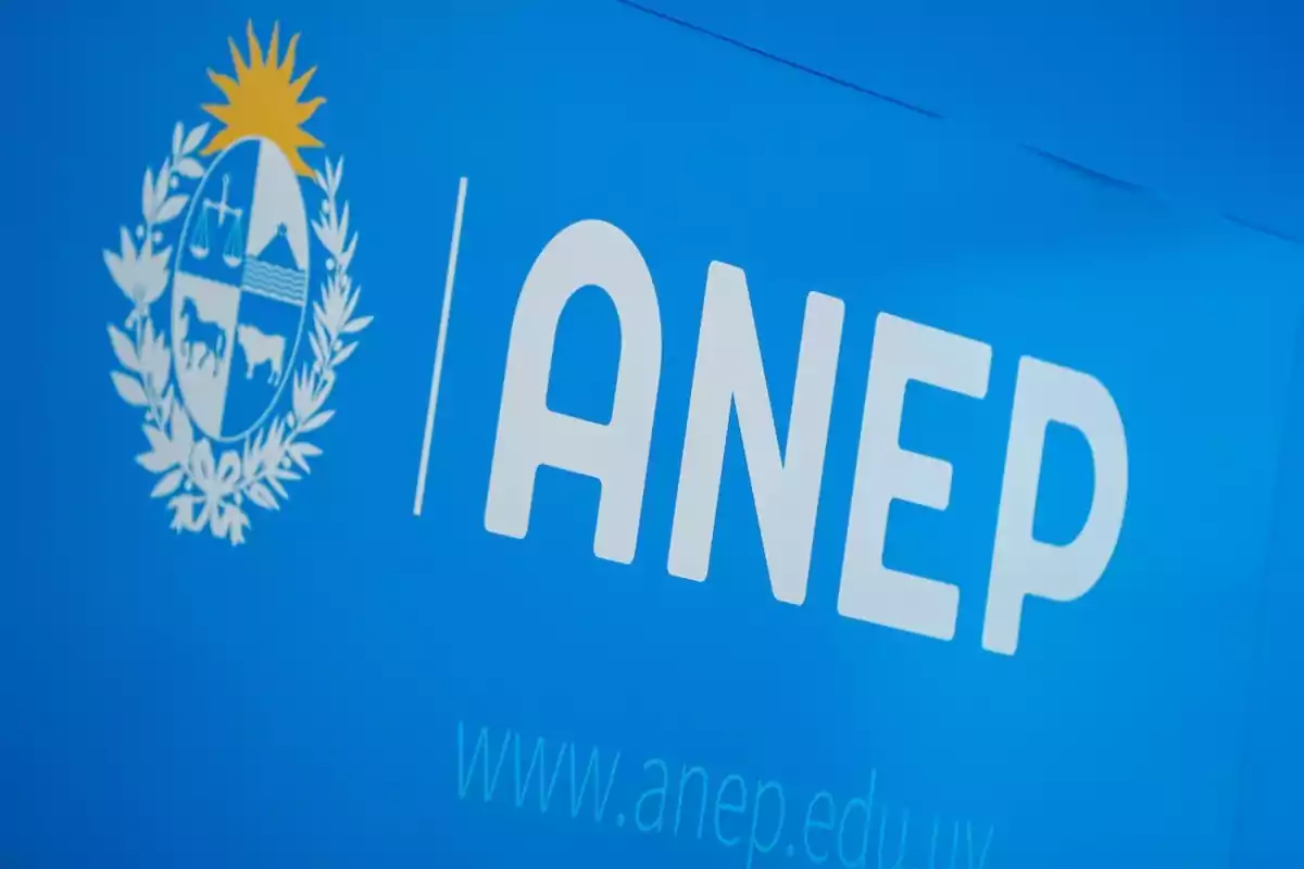 ANEP logo on a blue background next to the national coat of arms of Uruguay ANEP logo on a blue background next to the national coat of arms of Uruguay