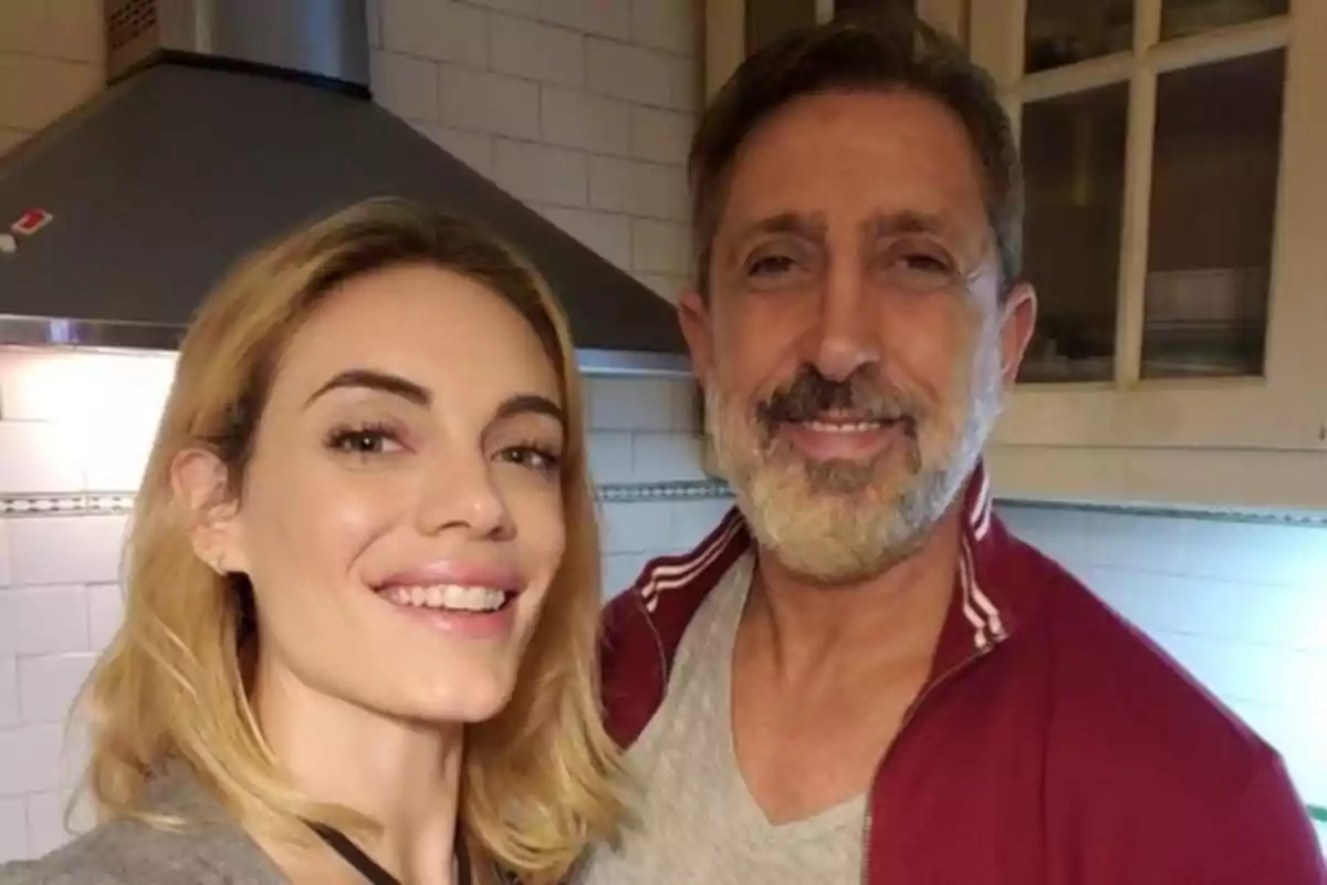 A woman and a man smile together in a kitchen. A woman and a man smile together in a kitchen.