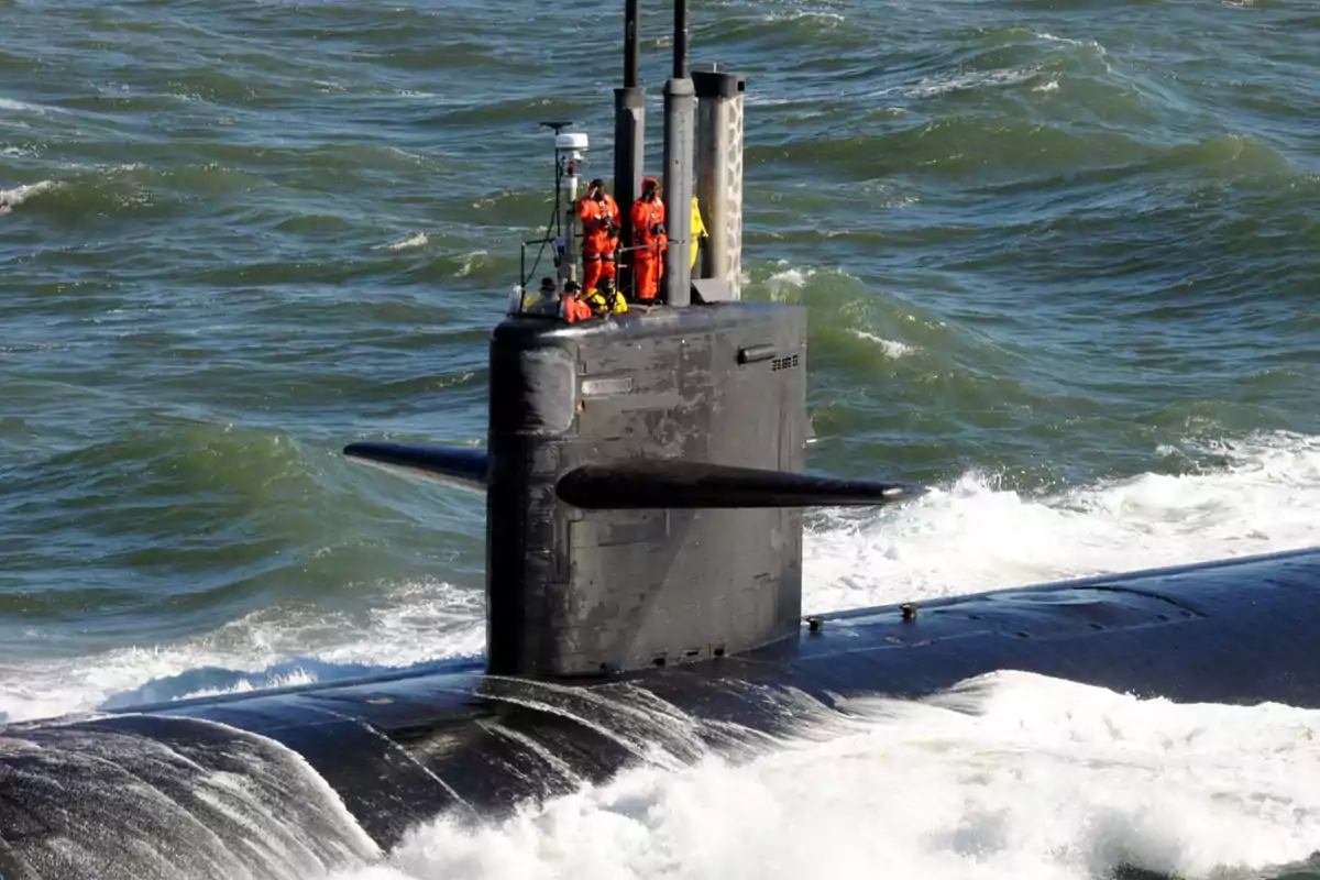 Submarine sailing on the surface of the sea with several people in the conning tower Submarine sailing on the surface of the sea with several people in the conning tower