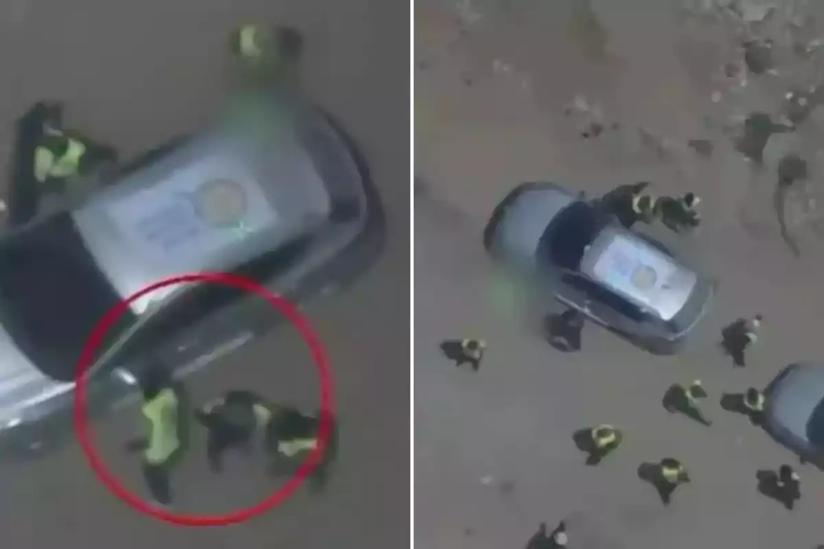 Several police officers surround a gray car seen from above in a dirt area. Several police officers surround a gray car seen from above in a dirt area.