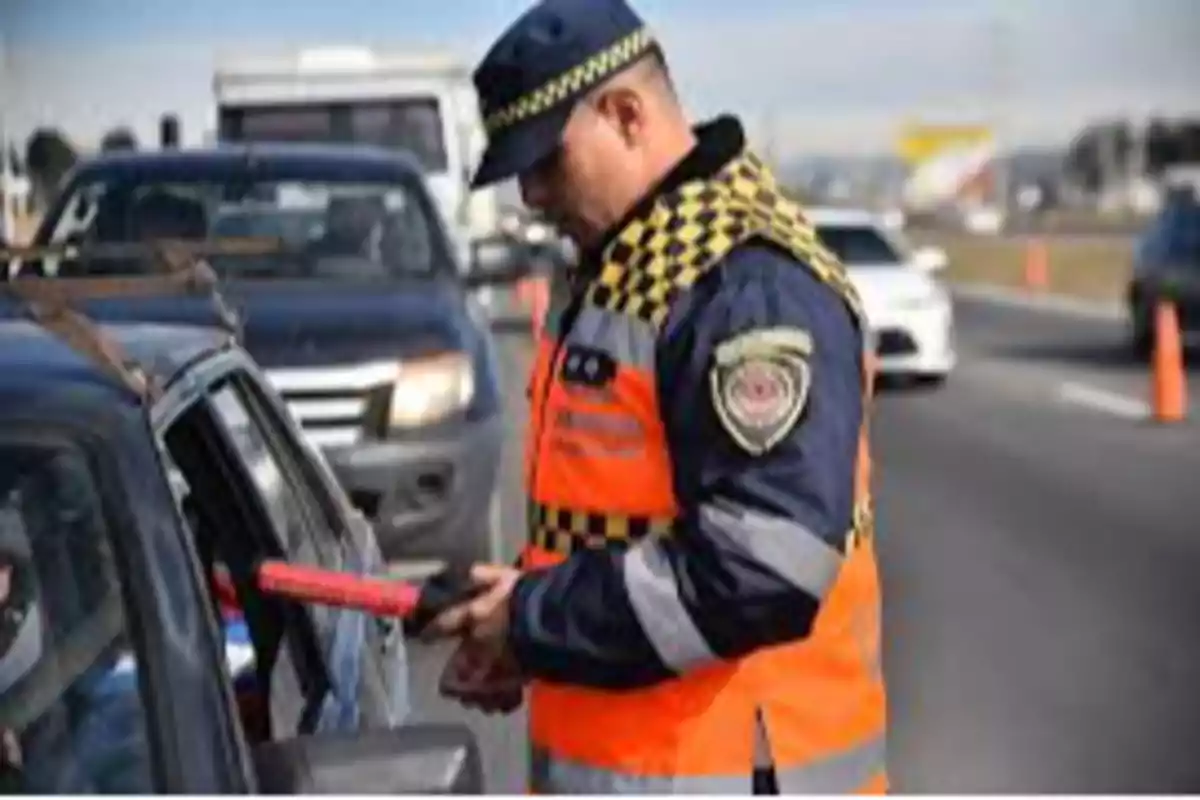 Traffic officer checking a driver's documents at a roadside checkpoint Traffic officer checking a driver's documents at a roadside checkpoint