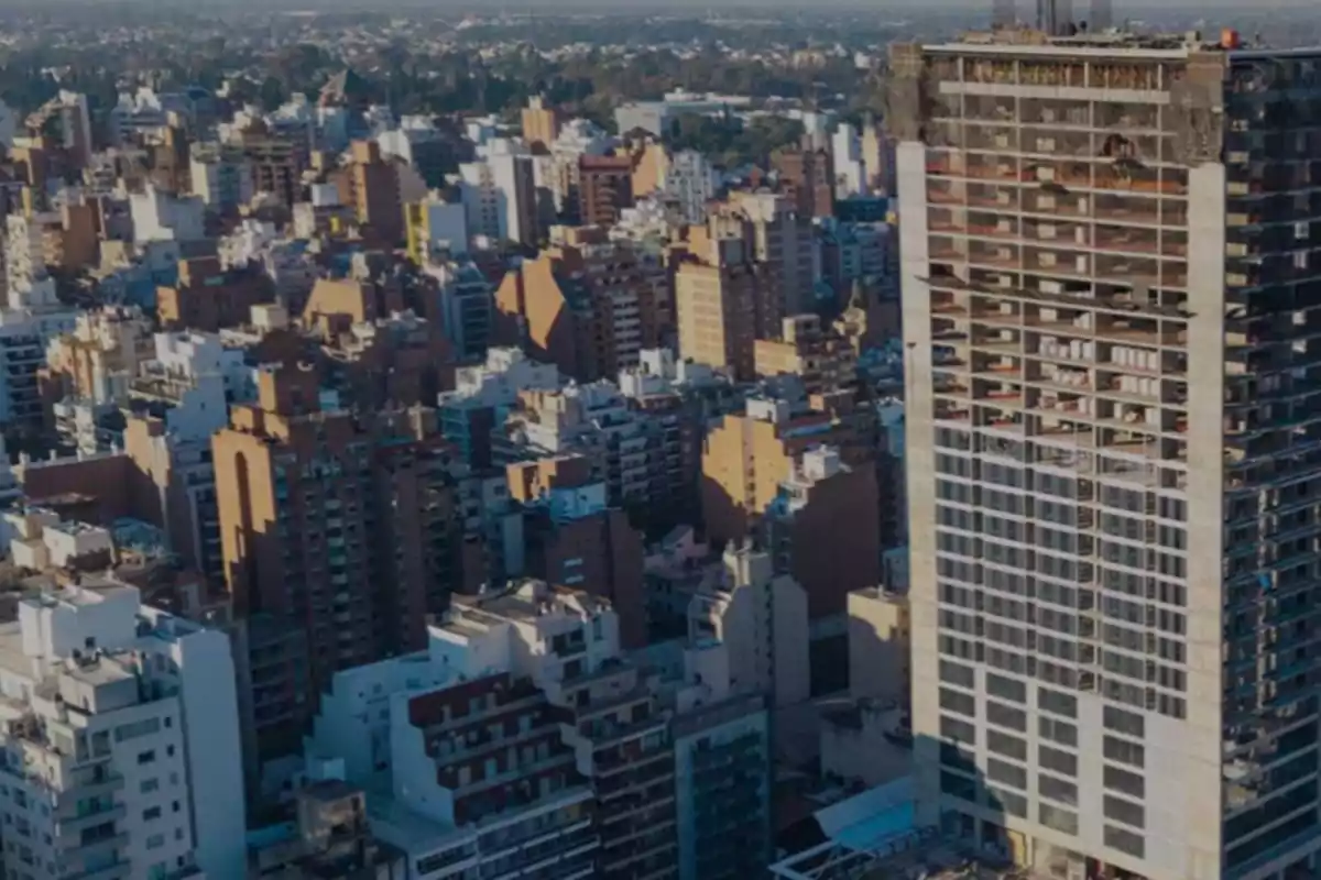 Panoramic view of a city with numerous buildings and a skyscraper under construction in the foreground Panoramic view of a city with numerous buildings and a skyscraper under construction in the foreground