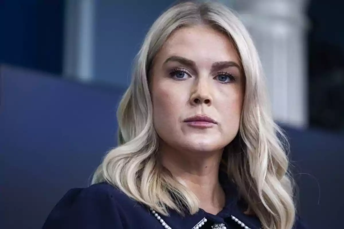 Blonde woman with loose hair and a serious expression with a blurred background Blonde woman with loose hair and a serious expression with a blurred background
