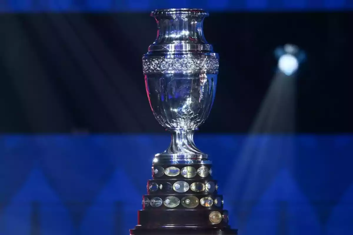 Copa América soccer trophy on a blue background with shining lights Copa América soccer trophy on a blue background with shining lights
