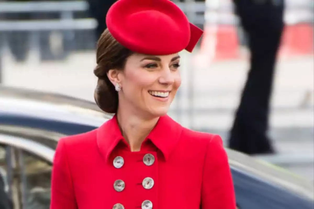 Smiling woman wearing an elegant red coat and hat